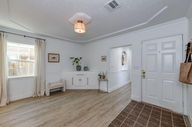 3519 N Van Ness Blvd, Fresno, CA 93704 - entryway with a decorative wall, crown molding, and wood finished floors