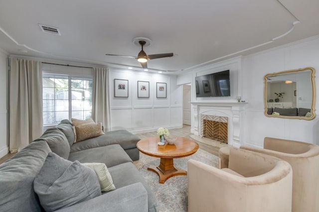 3519 N Van Ness Blvd, Fresno, CA 93704 - living room featuring a decorative wall, ornamental molding, a ceiling fan, a premium fireplace, and light wood finished floors