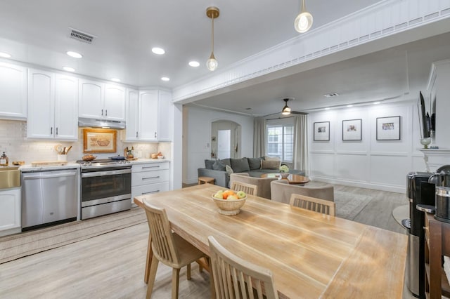 3519 N Van Ness Blvd, Fresno, CA 93704 - dining area with light wood finished floors, arched walkways, recessed lighting, and a ceiling fan