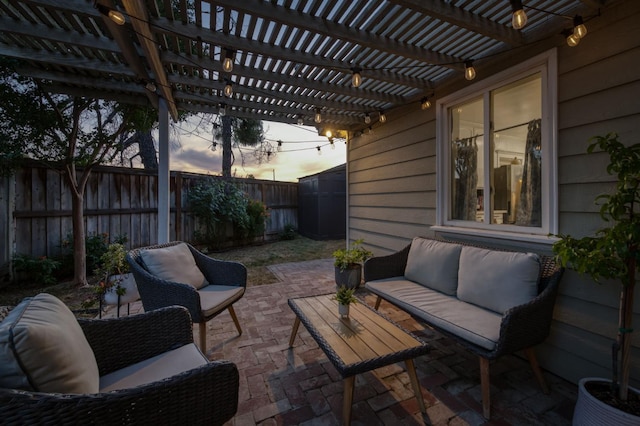 3519 N Van Ness Blvd, Fresno, CA 93704 - patio terrace at dusk with an outdoor living space, a pergola, and a fenced backyard