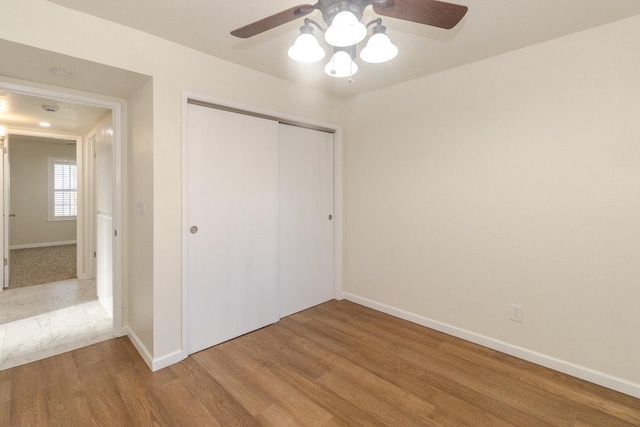 5455 N Marty Ave Unit 132, Fresno, CA 93711 - unfurnished bedroom featuring wood finished floors, a closet, baseboards, and ceiling fan