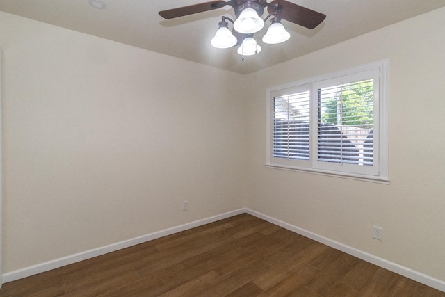 unfurnished room with baseboards, dark wood-style flooring, and ceiling fan