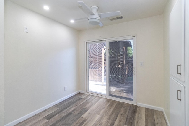 spare room with a ceiling fan, wood finished floors, baseboards, and recessed lighting