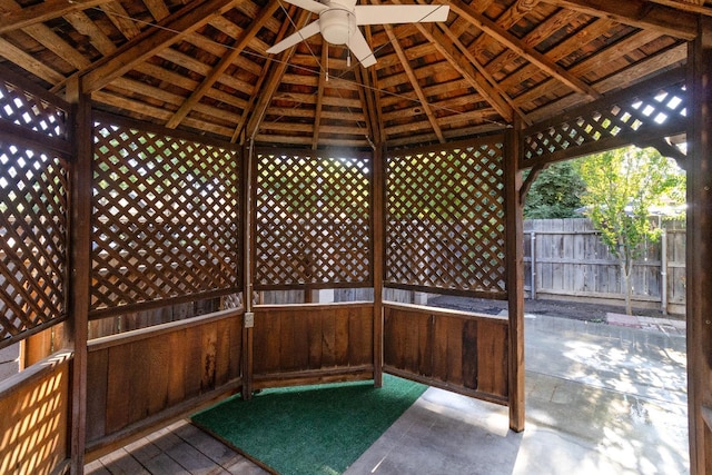 view of patio featuring ceiling fan and fence
