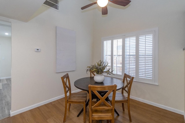 dining area with wood finished floors, ceiling fan, and baseboards