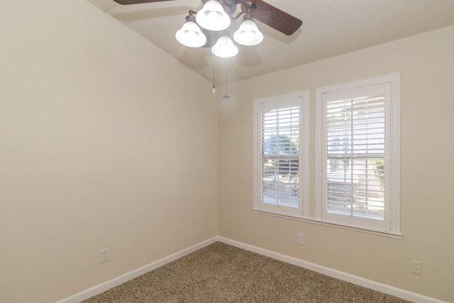 carpeted empty room with a ceiling fan and baseboards