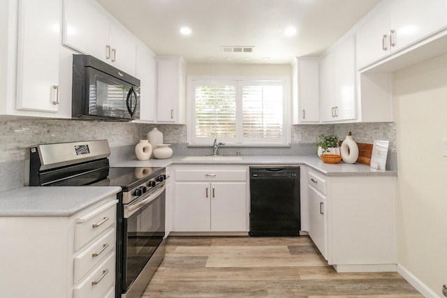 5455 N Marty Ave Unit 132, Fresno, CA 93711 - kitchen featuring black appliances, a sink, light wood-style flooring, tasteful backsplash, and light countertops