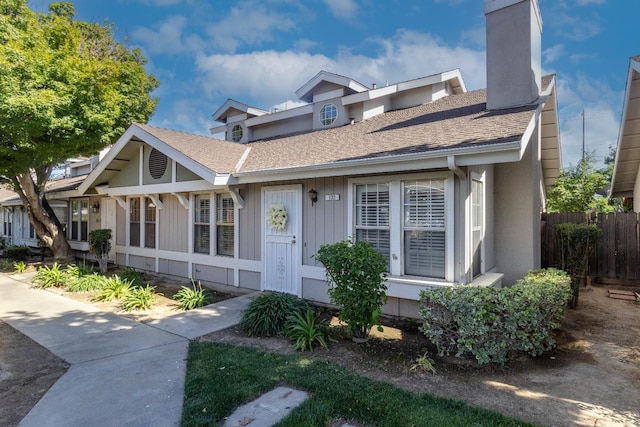 5455 N Marty Ave Unit 132, Fresno, CA 93711 - view of front of home with fence, a chimney, and roof with shingles