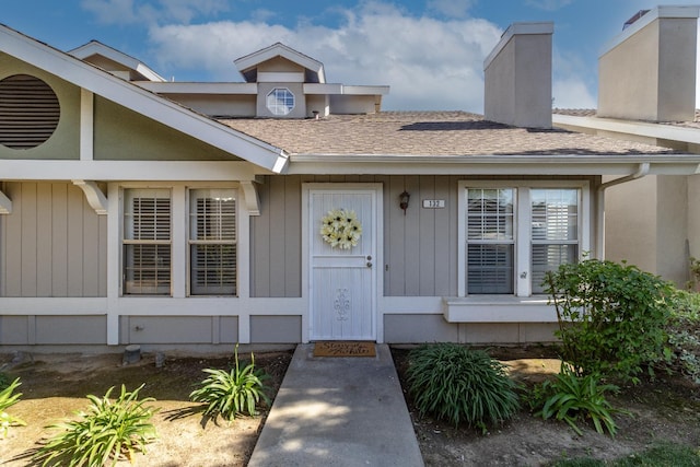 5455 N Marty Ave Unit 132, Fresno, CA 93711 - property entrance featuring a chimney and a shingled roof