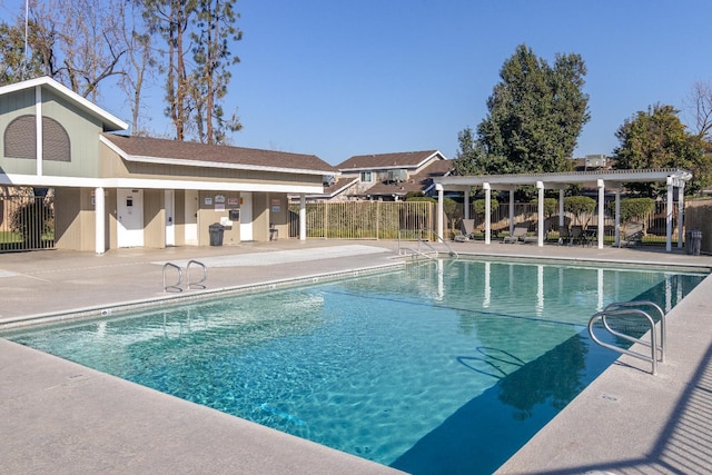 community pool with fence and a patio area