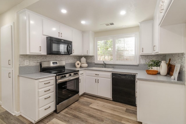 5455 N Marty Ave Unit 132, Fresno, CA 93711 - kitchen with black appliances, a sink, light wood-style floors, backsplash, and recessed lighting