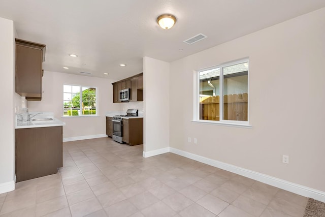 35 E Florence Ave, Fresno, CA 93706 - kitchen featuring appliances with stainless steel finishes, light countertops, baseboards, a sink, and recessed lighting