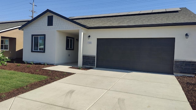 35 E Florence Ave, Fresno, CA 93706 - view of front of home featuring a shingled roof, an attached garage, solar panels, and driveway