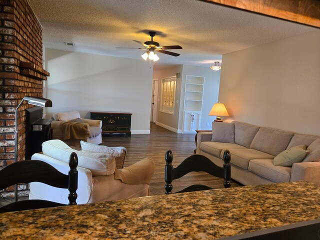 1489 Celeste Ave, Clovis, CA 93611 - living area with wood finished floors, ceiling fan, a textured ceiling, baseboards, and built in shelves