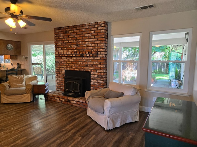 1489 Celeste Ave, Clovis, CA 93611 - living room featuring dark wood-type flooring, a ceiling fan, a textured ceiling, and a brick fireplace