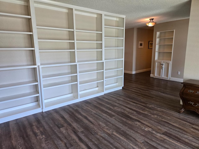 1489 Celeste Ave, Clovis, CA 93611 - unfurnished living room featuring dark wood-style flooring, a textured ceiling, and baseboards