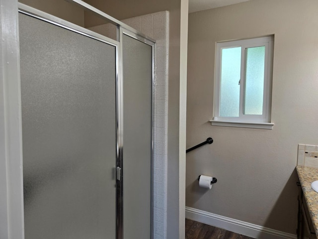 1489 Celeste Ave, Clovis, CA 93611 - bathroom with a stall shower, baseboards, vanity, and wood finished floors