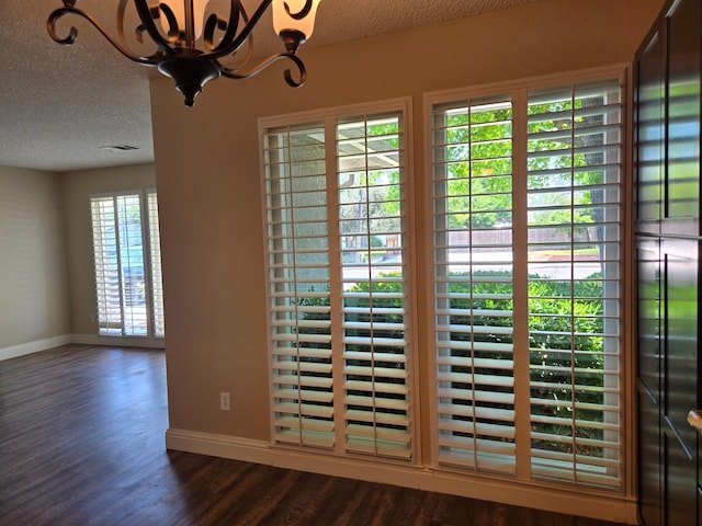 1489 Celeste Ave, Clovis, CA 93611 - detailed view of baseboards, wood finished floors, a textured ceiling, and a chandelier