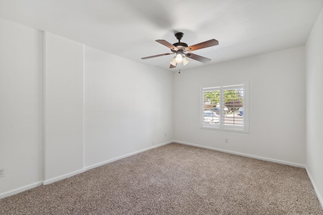 unfurnished room featuring carpet floors, a ceiling fan, and baseboards