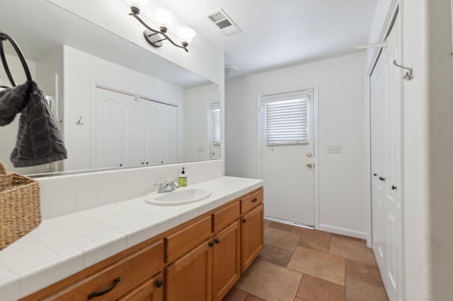 bathroom featuring vanity and stone finish floors