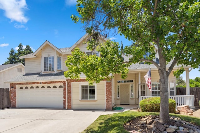 view of front of home with brick siding, fence, driveway, and a shingled roof
