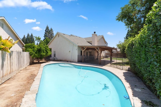 view of pool with a fenced backyard