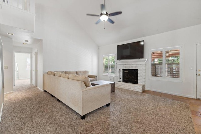 living room featuring ceiling fan, high vaulted ceiling, and a brick fireplace