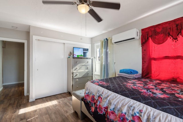 2140 E Floradora Ave, Fresno, CA 93703 - bedroom with a wall unit AC, wood finished floors, ceiling fan, and a closet