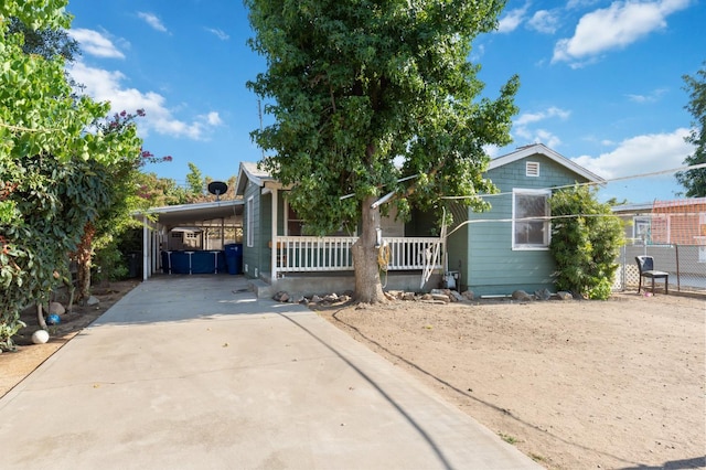 2140 E Floradora Ave, Fresno, CA 93703 - view of front facade with driveway, covered porch, a carport, and fence