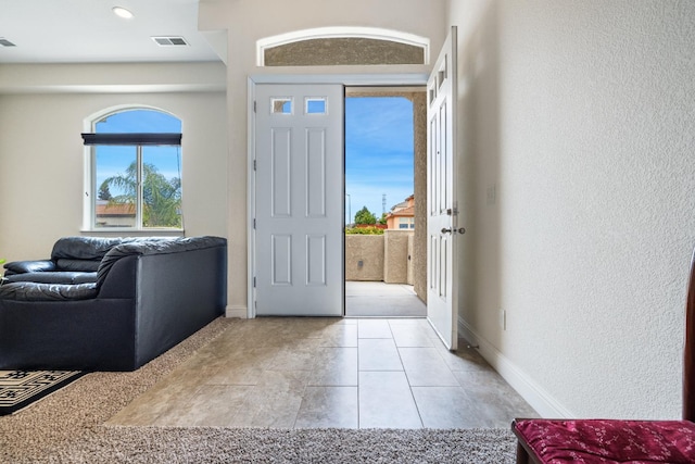 5279 N Ensanada Ave, Fresno, CA 93723 - foyer featuring baseboards, a textured wall, and light tile patterned floors