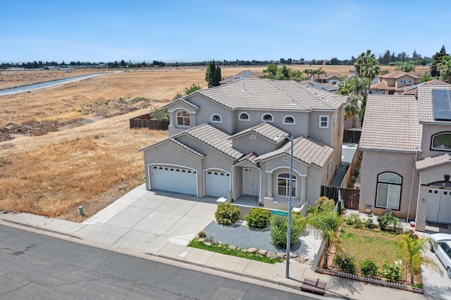 5279 N Ensanada Ave, Fresno, CA 93723 - view of front of house with driveway, stucco siding, an attached garage, and a tiled roof