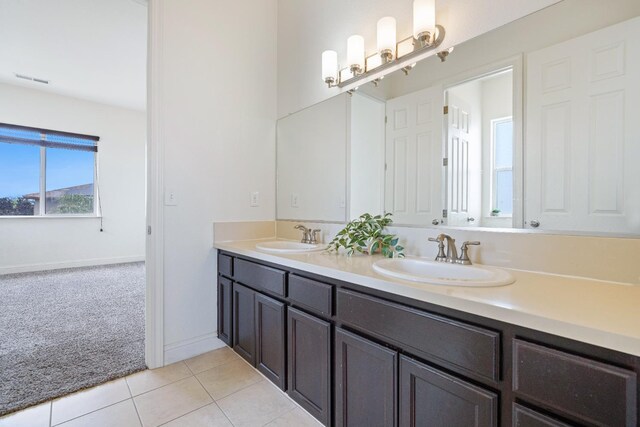 5279 N Ensanada Ave, Fresno, CA 93723 - full bathroom with tile patterned flooring, double vanity, and baseboards