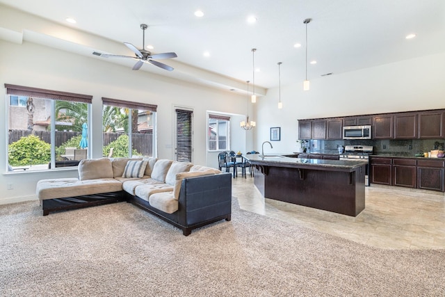 5279 N Ensanada Ave, Fresno, CA 93723 - living room with recessed lighting, a chandelier, a towering ceiling, ceiling fan, and baseboards