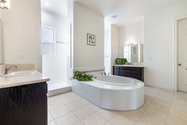 5279 N Ensanada Ave, Fresno, CA 93723 - bathroom featuring tile patterned floors, a bath, two vanities, and tiled shower