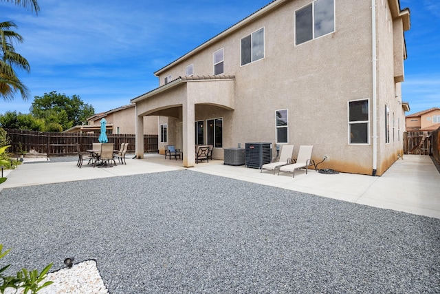 5279 N Ensanada Ave, Fresno, CA 93723 - rear view of house featuring stucco siding, a fenced backyard, a patio, and cooling unit