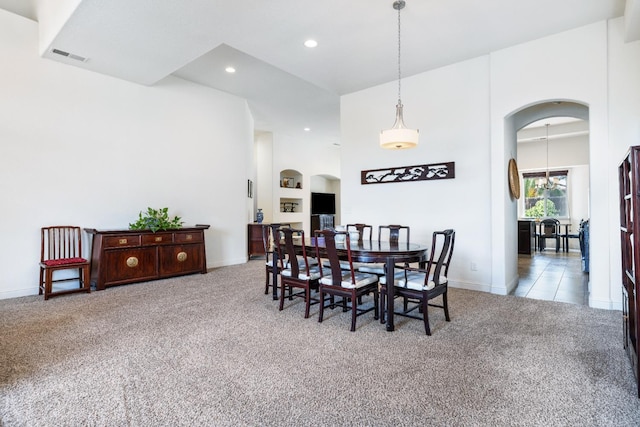 5279 N Ensanada Ave, Fresno, CA 93723 - dining room featuring arched walkways, carpet flooring, recessed lighting, baseboards, and a high ceiling
