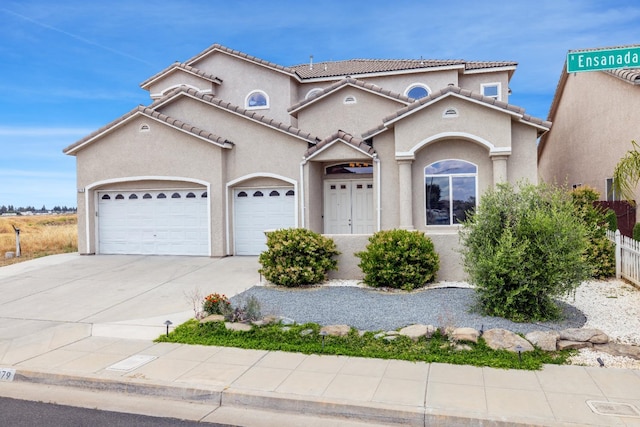 5279 N Ensanada Ave, Fresno, CA 93723 - mediterranean / spanish-style home with stucco siding, a garage, driveway, a tiled roof, and fence