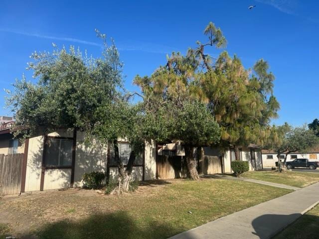 obstructed view of property with a front yard