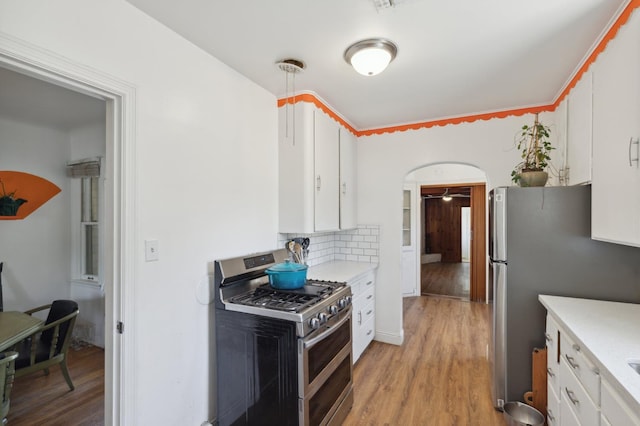 2020 N Fruit Ave, Fresno, CA 93705 - kitchen featuring stainless steel appliances, white cabinetry, light countertops, light wood finished floors, and decorative backsplash