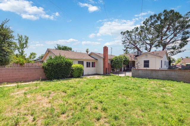 2020 N Fruit Ave, Fresno, CA 93705 - rear view of property with a chimney