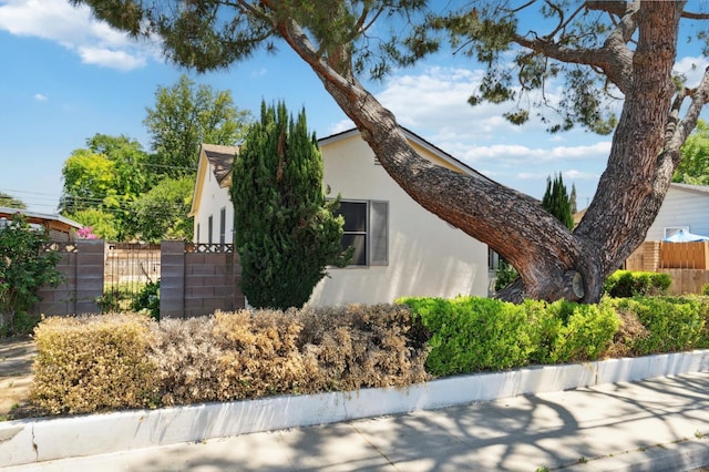 2020 N Fruit Ave, Fresno, CA 93705 - view of home's exterior featuring stucco siding and fence