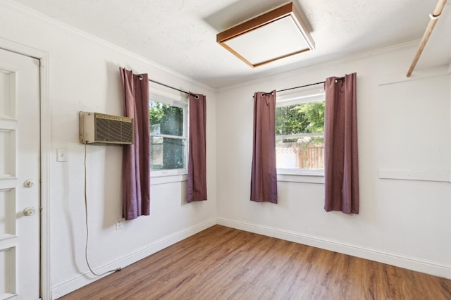 2020 N Fruit Ave, Fresno, CA 93705 - spare room with attic access, wood finished floors, a wall unit AC, crown molding, and baseboards