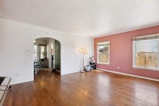 2020 N Fruit Ave, Fresno, CA 93705 - empty room featuring arched walkways and wood finished floors