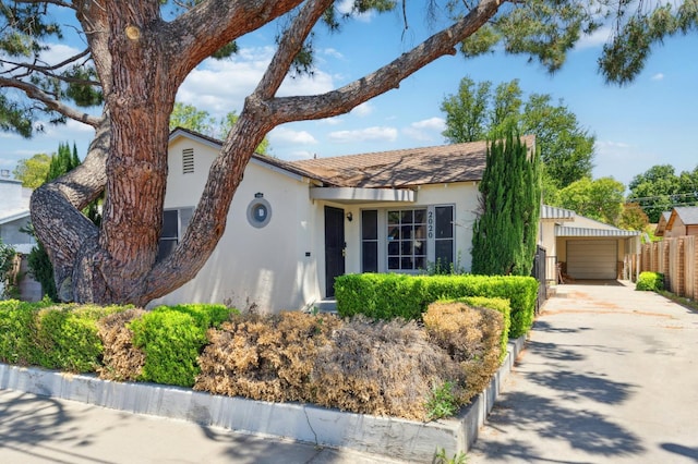 2020 N Fruit Ave, Fresno, CA 93705 - single story home featuring stucco siding, fence, driveway, and a detached garage