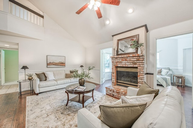 198 Decatur Ave, Clovis, CA 93611 - living area featuring a ceiling fan, high vaulted ceiling, a fireplace, wood finished floors, and baseboards