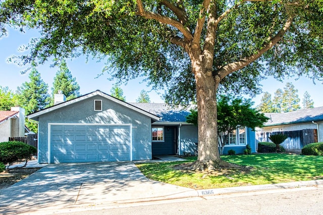 6365 N Barcus Ave, Fresno, CA 93722 - ranch-style house featuring an attached garage, driveway, a chimney, and stucco siding