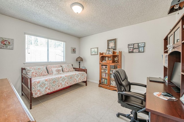 6365 N Barcus Ave, Fresno, CA 93722 - bedroom with a textured ceiling, an office area, and light tile patterned floors