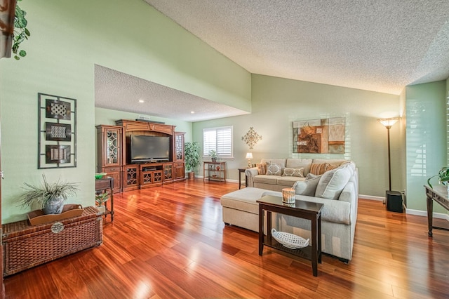 6365 N Barcus Ave, Fresno, CA 93722 - living area featuring a textured ceiling, wood finished floors, high vaulted ceiling, and baseboards