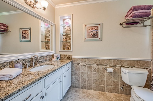 6365 N Barcus Ave, Fresno, CA 93722 - bathroom featuring crown molding, toilet, tile walls, vanity, and wainscoting