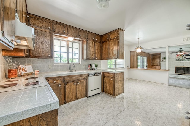 kitchen featuring white appliances, a sink, custom range hood, and light countertops